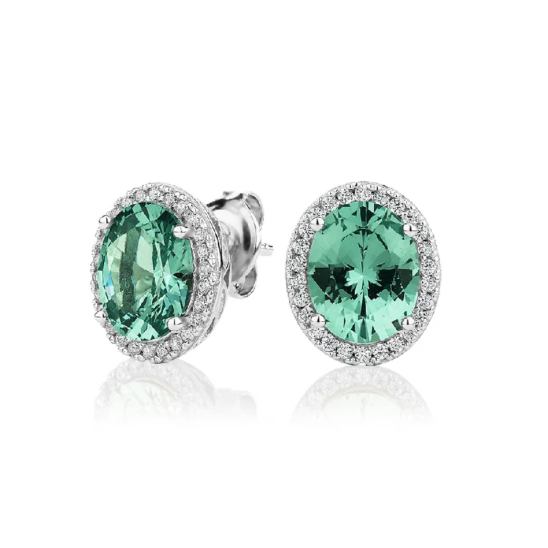 Modern Jewelry At Exclusive Discounts – Shop Today Oval and Round Brilliant halo stud earrings with ocean green simulants and 0.34 carats* of diamond simulants Modern Jewelry At Exclusive Discounts – Shop Today Oval and Round Brilliant halo stud earrings with ocean green simulants and 0.34 carats* of diamond simulants
